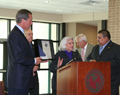 Senator speaking with, Lieutenant Governor and University President Standing Beside Her