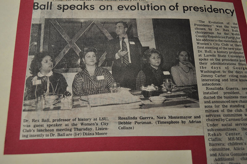 Dr. Rex Ball (standing) is lecturing while four women are pictured listening intently.