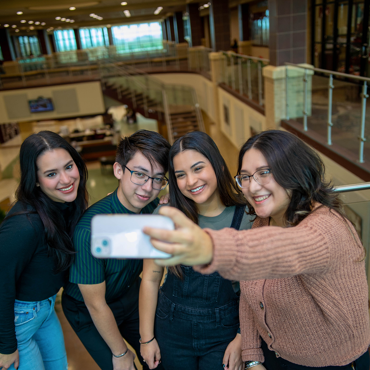 Four students taking a selfie at the Zaffirini Student Success Center