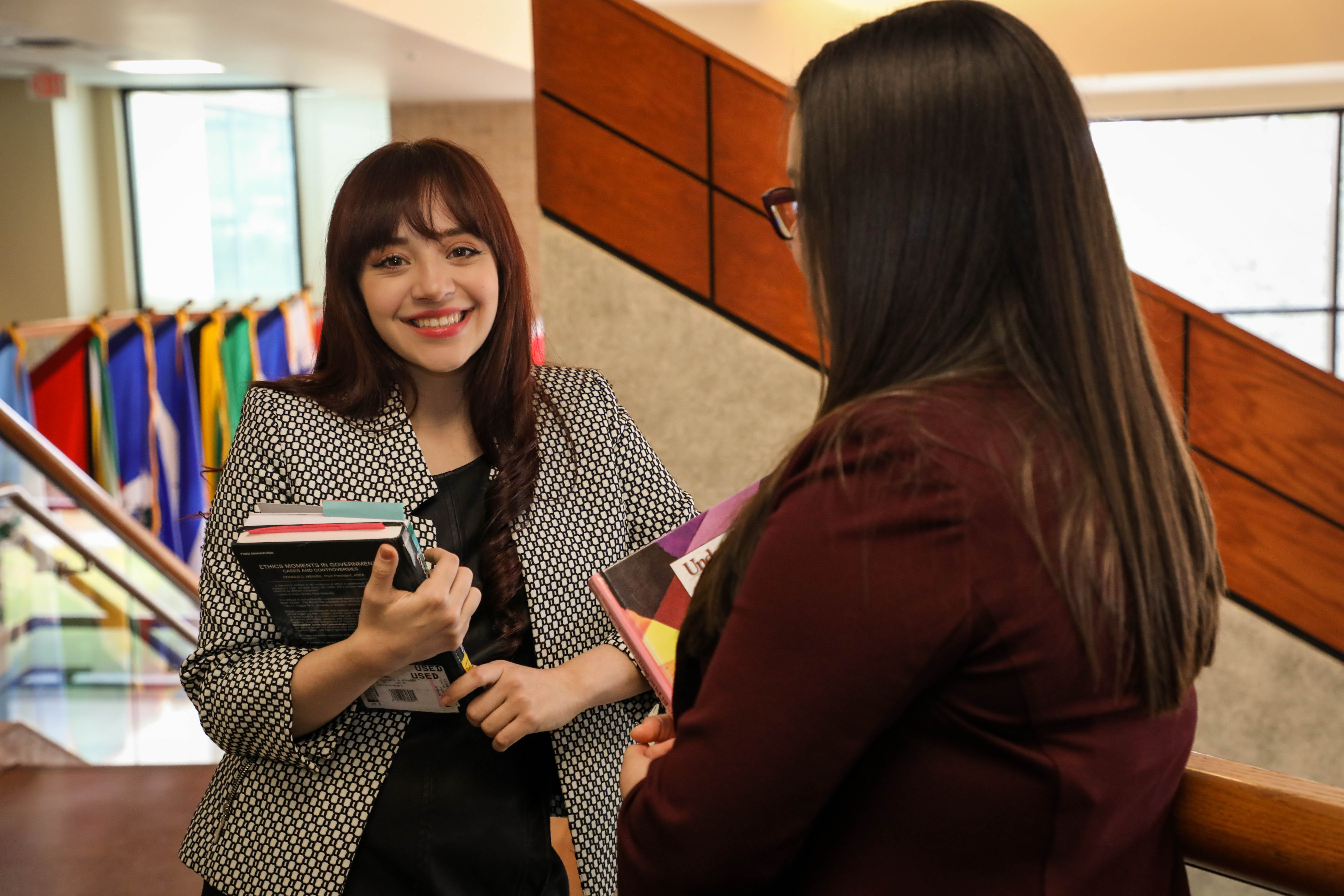 Graduate Students in the School of Business with textbooks.