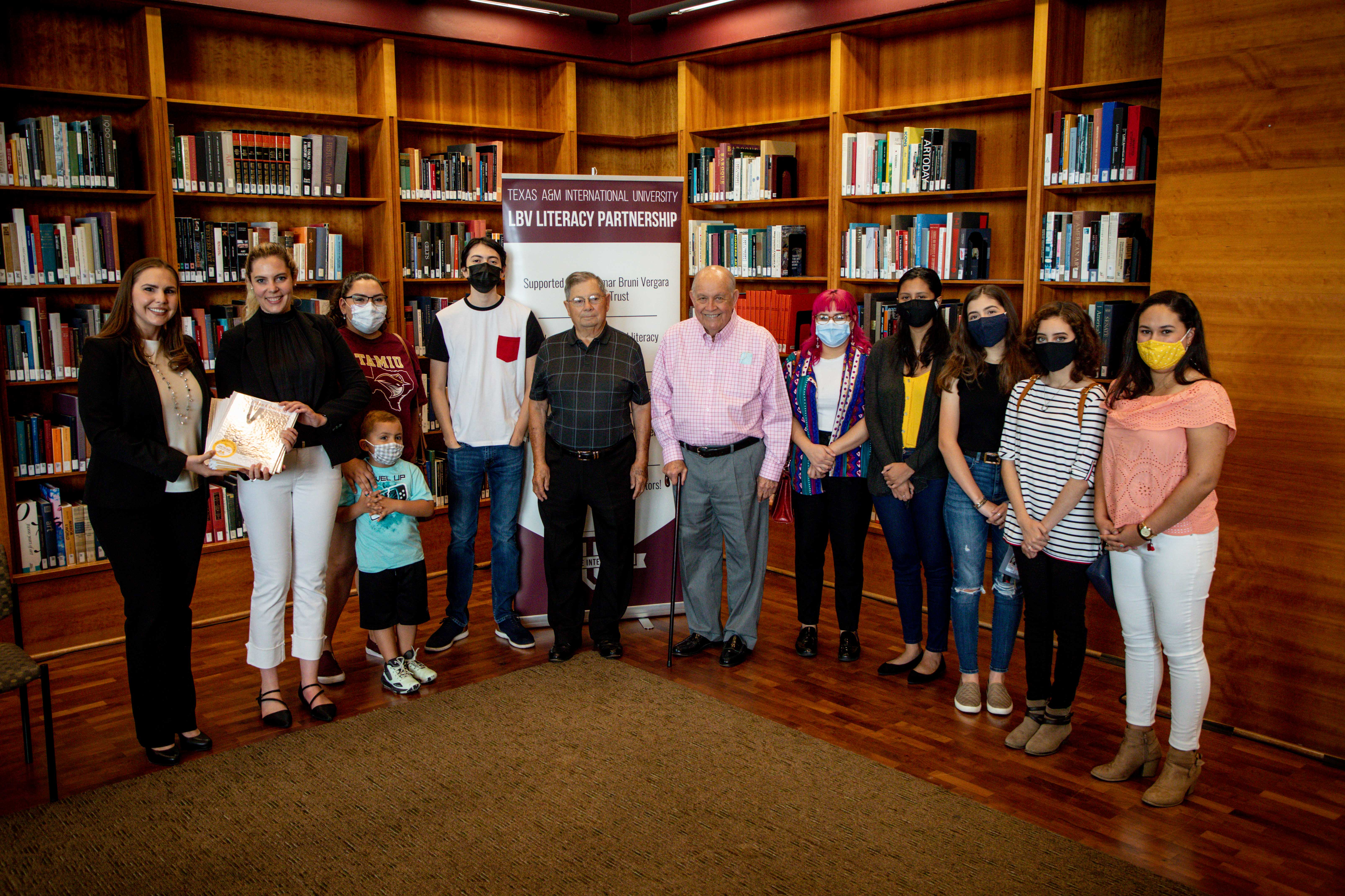 a group of TAMIU Children's Literature students pose with their newly created books