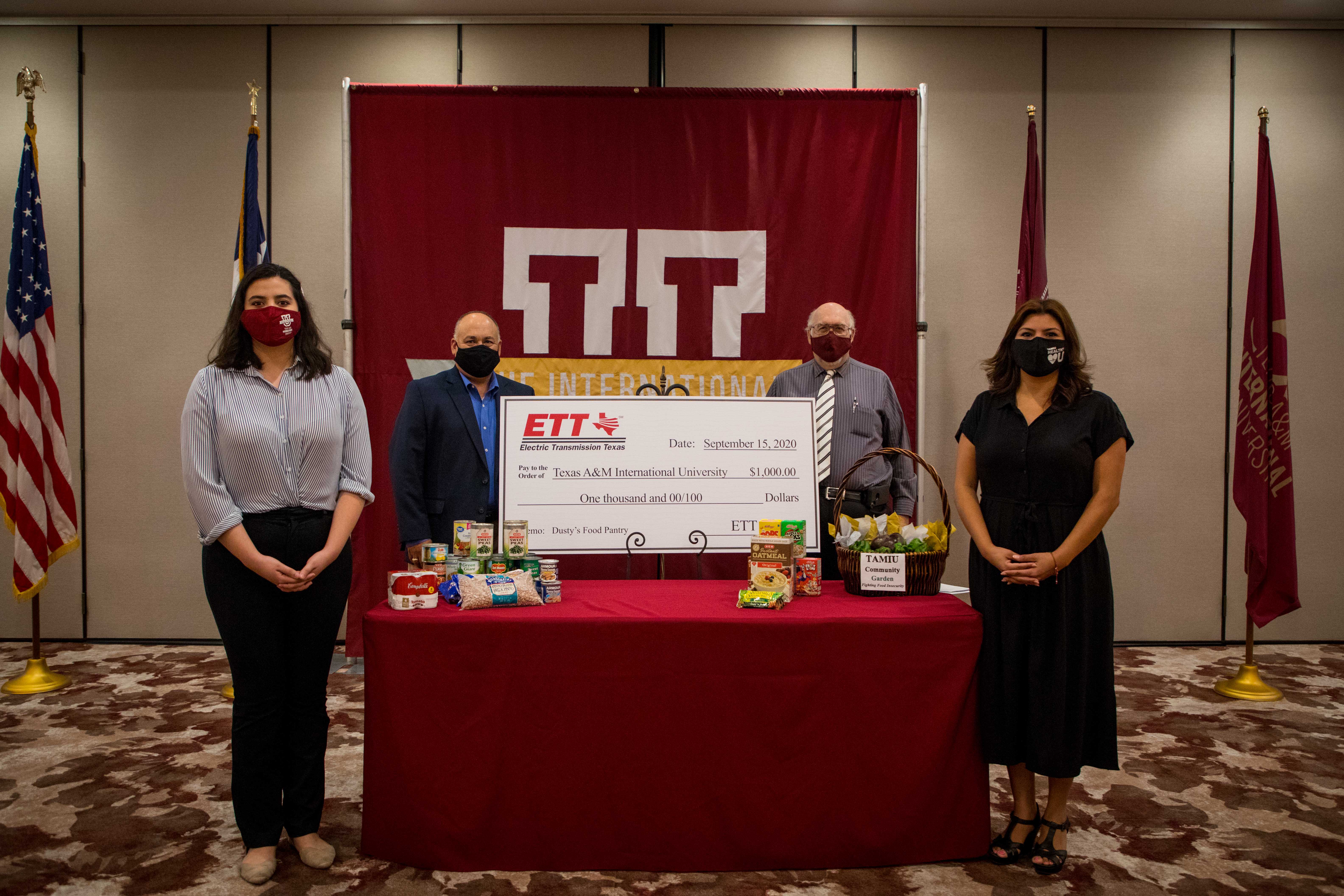 TAMIU students will benefit from a $1,000 donation made to Dusty’s Food Pantry provided by Electric Transmission Texas. Present at the check presentation were (standing, from L-R) Mariana Rodriguez, Tony Arce Jr., Dr. Pablo Arenaz, and Mayra Hernandez. 