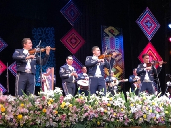 Mariachi players on stage performing.
